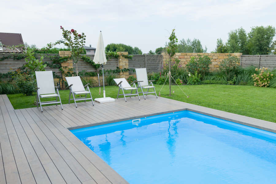 Outdoor swimming pool on private residence, lawn, garden