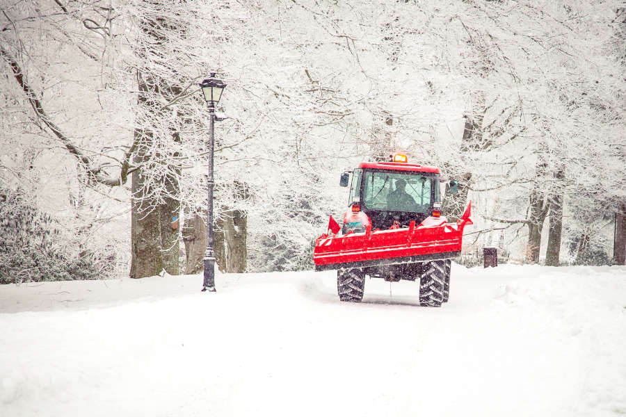 big tractor cleans road from snow in the winter. seasonal work